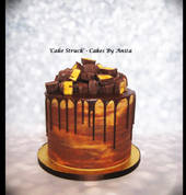 Layered Chocolate Cake filled with Caramel Buttercream and Chocolate Ganache and finished with a Ganache drip and covered in Hokey Pokey pieces.