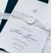 Handmade paper invitations with silk ribbon and wax seals